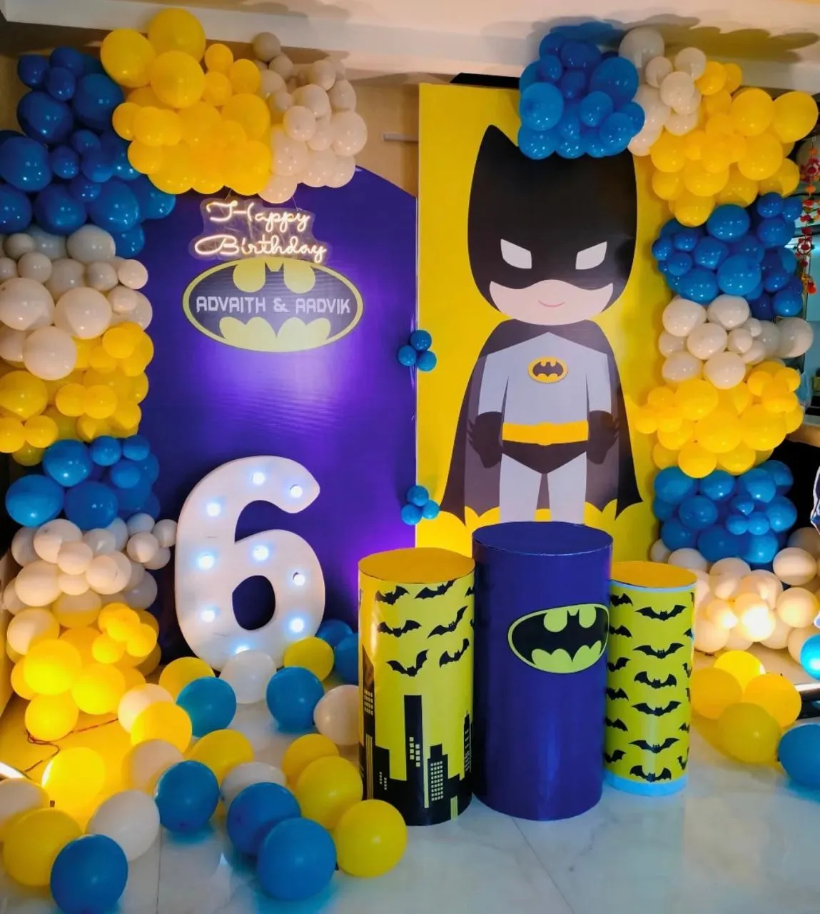 Batman Theme with balloons, 3 round cake boxes, LED age, welcome board and 4 LED lights.