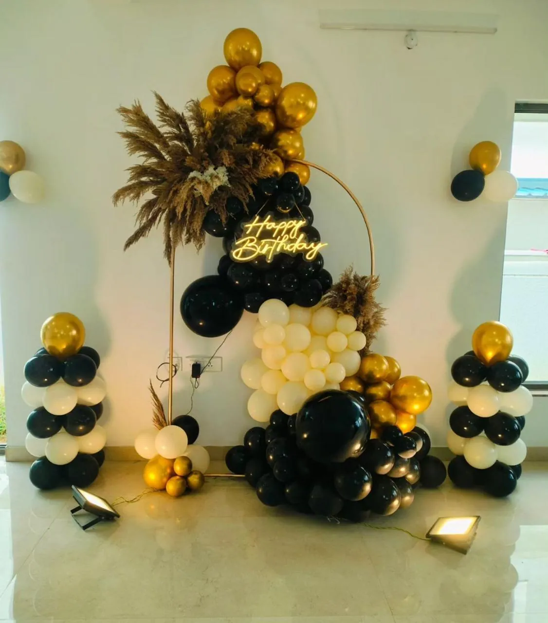 Black, white and gold balloon arch for an adult birthday