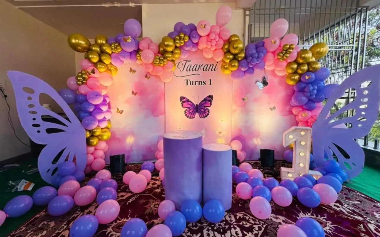 Purple butterfly themed first birthday stage