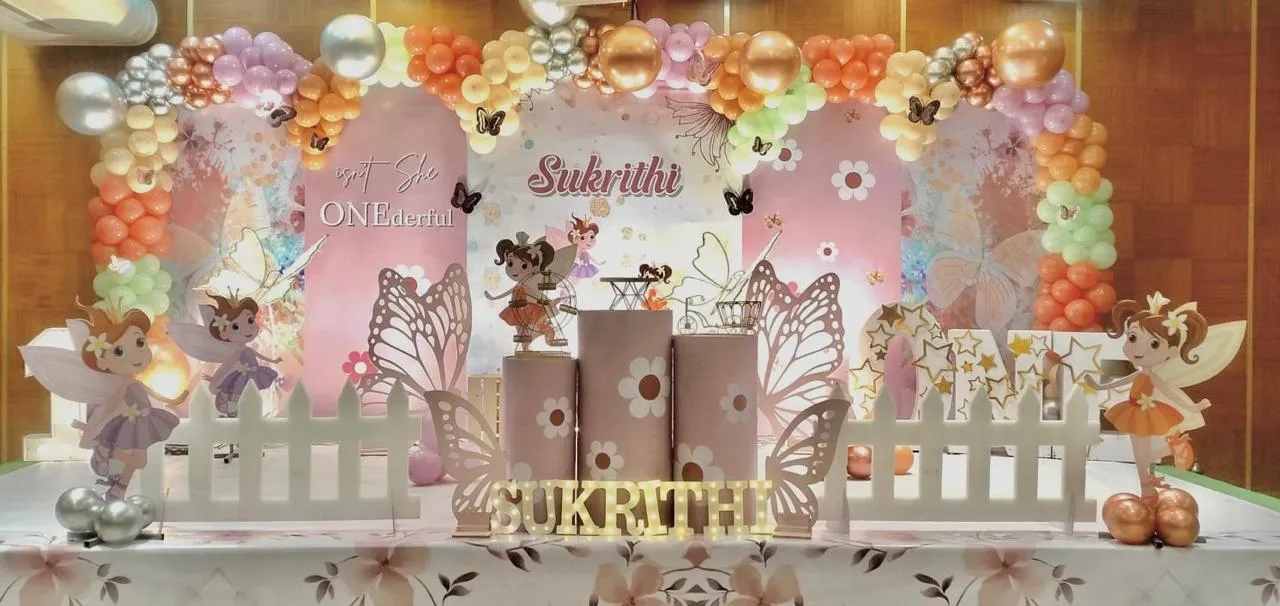 Onederful Fairy Theme with balloons, 3 cake tables, table with paper stars, LED name & age, 4 Wooden Butterflies and balloons arch.