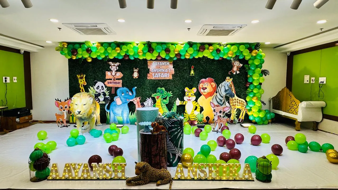 Jungle safari themed birthday stage with animal cutouts