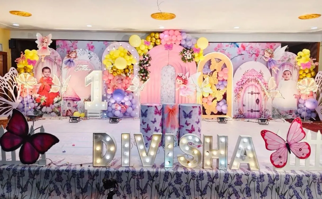 premium butterfly & fairy theme with Beautiful Balloon Arch, 3 cake table, Led name and flowers and lights.